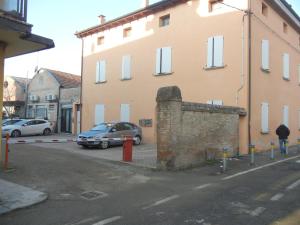 a car parked in a parking lot next to a building at CASA VACANZE MEDICINA in Medicina