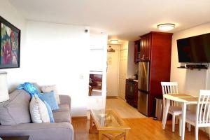 a living room with a couch and a table at Waikiki Marina Studio, Ocean view, Free Parking & Wifi in Honolulu
