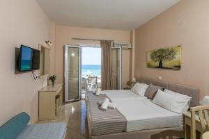 a hotel room with a bed and a television at Marilyn Apartments in Rethymno Town