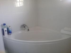 a white bathroom sink with a faucet and towels at The Star B&B in Jwaneng +12 photos