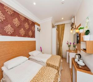 Postel nebo postele na pokoji v ubytování Raimond Hotel