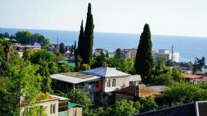 a group of houses on a hill near the ocean at Вита Гагра in Gagra