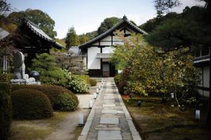 a pathway in front of a house with a building at Kumano House in Kyoto
