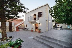 a large courtyard with stairs leading to a house at Villa Christini a luxury villa with amazing views in Tzitzifés