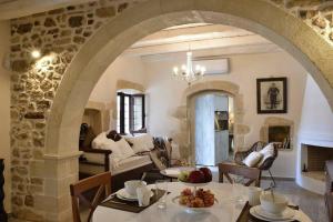 an archway in a living room with a table and chairs at Villa Christini a luxury villa with amazing views in Tzitzifés