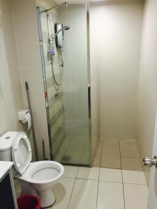 a bathroom with a shower and a toilet at Menara U Shah Alam Guest House in Shah Alam