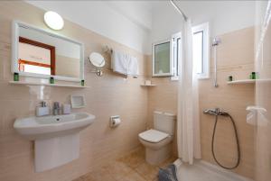 a bathroom with a sink and a toilet and a shower at Irene Studios - Beachfront in Parikia +42 photos