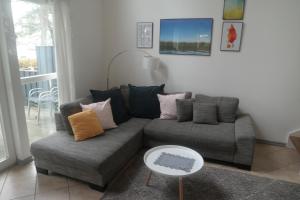 a living room with a couch and a table at Schlosspark Bad Saarow in Bad Saarow