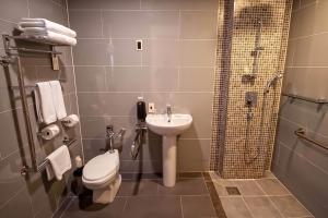a bathroom with a toilet and a sink and a shower at Holiday Inn Gwangju, an IHG Hotel in Gwangju