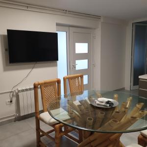 a dining room with a glass table and two chairs at Apartma Pata, Koper - Čežarji in Čežarji