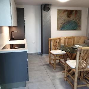 a kitchen and dining room with a table and chairs at Apartma Pata, Koper - Čežarji in Čežarji