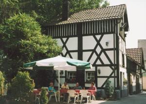 a group of people sitting at a table in front of a building at Hotel-Restaurant-Kolb in Illertissen