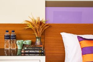 a head board with books and water bottles on it at Studio Asoke in Bangkok