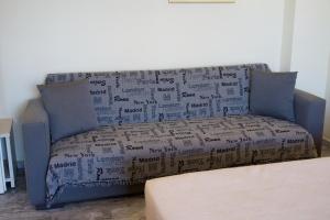 a couch covered in boxes in a living room at Prince Studios in Sami