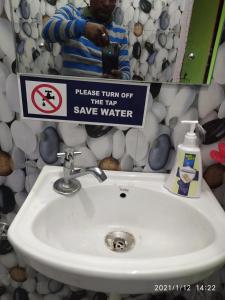 a sign above a sink in a bathroom at MangalMurti Himalyan Homestay in Hawālbāgh +52 photos