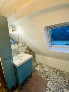 a bathroom with a sink and a window at Le Lavoir aux Roses by Gîtes Sud Touraine in Chédigny +24 photos