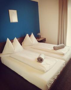 2 Betten in einem Hotelzimmer mit Handtüchern darauf in der Unterkunft Garni Weisser Wolf - Bed & Breakfast in Friesach