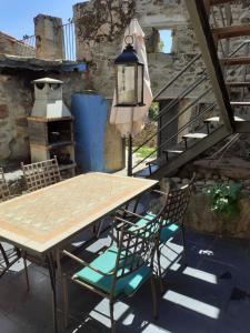 a table and chairs on a patio with a stove at El Patio Chico in Los Loros