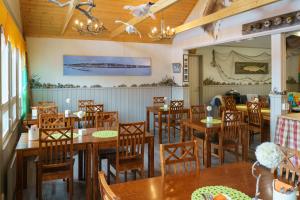 a dining room table and chairs in a restaurant at Holiday Village Nuorgamin Lomakeskus in Nuorgam