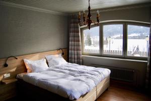 a bedroom with a bed and a large window at Hotel Speiereck in Sankt Michael im Lungau