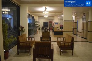 a lobby with chairs and tables in a building at Hotel Murud Marina in Murud +29 photos