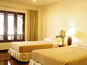 Ein Bett oder Betten in einem Zimmer der Unterkunft Baan Klang Aow Beach Resort