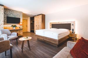 a bedroom with a bed and a living room at Hotel Laudinella in St. Moritz