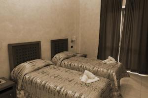 Posteľ alebo postele v izbe v ubytovaní Hotel Ulisse