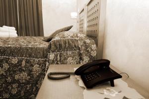 Posteľ alebo postele v izbe v ubytovaní Hotel Ulisse