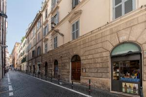 a brick building with a store on a street at Daphne Luxury Suites in Rome