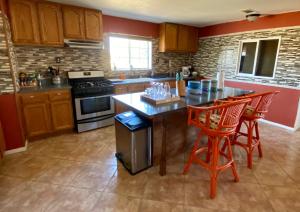 a kitchen with a table and two red chairs at Casa De Frank in Joshua Tree