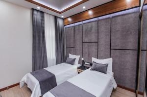 a bedroom with two beds in a room at Art Deluxe Hotel in Tashkent +29 photos