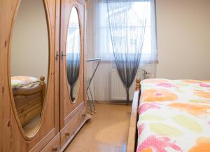 1 dormitorio con tocador de madera junto a la cama en Ferienwohnungen Wittmann, Wohnung 1.OG en Bad Staffelstein