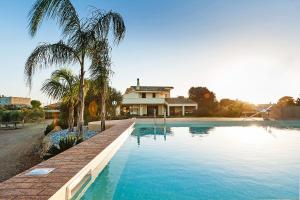 a large swimming pool in front of a house at Villa Laura in Marsala
