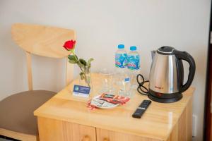 a table with a tea kettle and water bottles at Biển Nhớ Hotel & Coffee in Phan Thiet