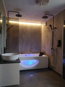 a bathroom with a large tub and a sink at Villa Korkatti in Haapavesi +58 photos