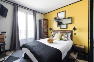 a bedroom with a large bed and a large window at Madrigal in Paris