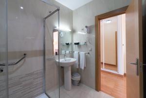 a bathroom with a sink and a glass shower at Rincón Sol in Rincón de la Victoria