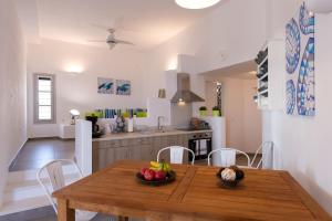 a kitchen and dining room with a wooden table and chairs at Grey House in Exámbela