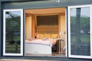 a bedroom with a bed inside of a window at The Fox Den in Rhayader