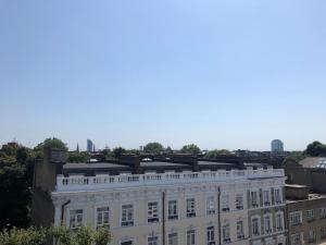 a white building with a sign on the top of it at My Place Hotel in London