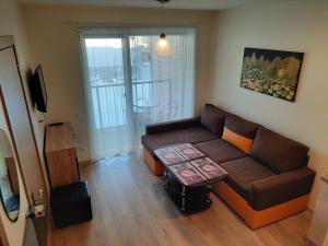 a living room with a couch and a table at Maluno Vilos in Palanga