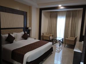 Voodi või voodid majutusasutuse Hotel Aadithya toas