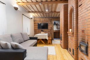 a living room with a couch and a brick wall at Haanjamehe Taluhotell in Haanja