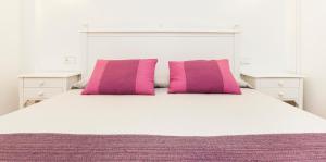מיטה או מיטות בחדר ב-Insotel Club Tarida Playa