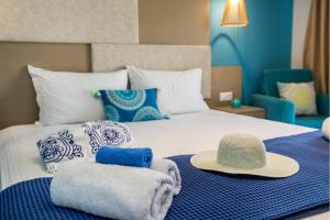 a bedroom with a bed with hats on it at Iria's Luxury Apartments in Limenaria