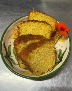 a plate with three slices of cake with a flower on it at Sítio Tamanduá in Brotas +18 photos