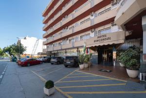 a parking lot with cars parked in front of a building at Rincón Sol in Rincón de la Victoria