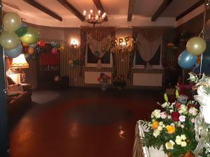 a room with balloons and a table with flowers at Drawa in Przesieki