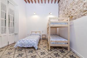a bedroom with a bunk bed and two beds at Apartamentos Teatro Alicante in Alicante